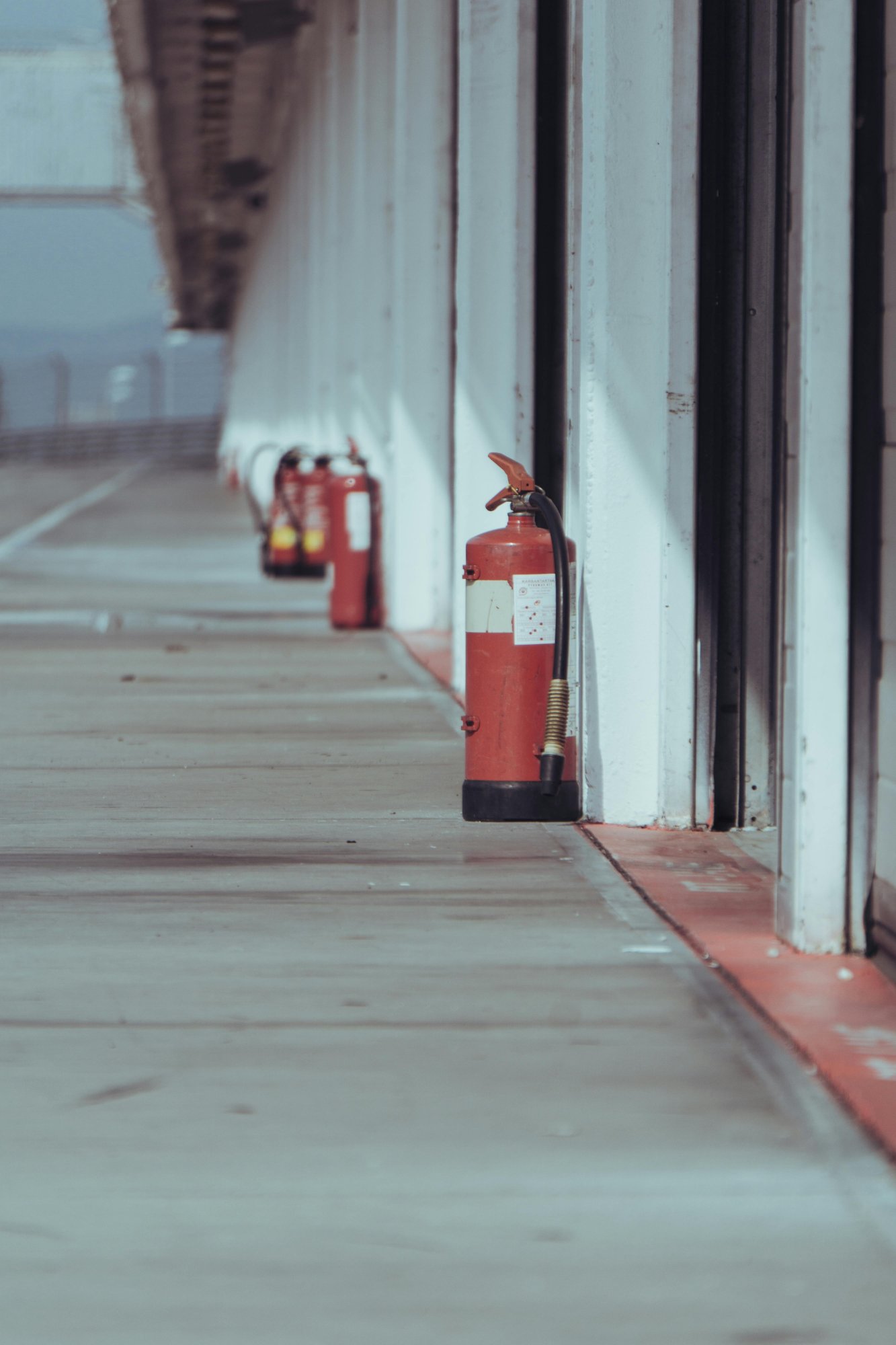 Row of fire extinguishers in corridor