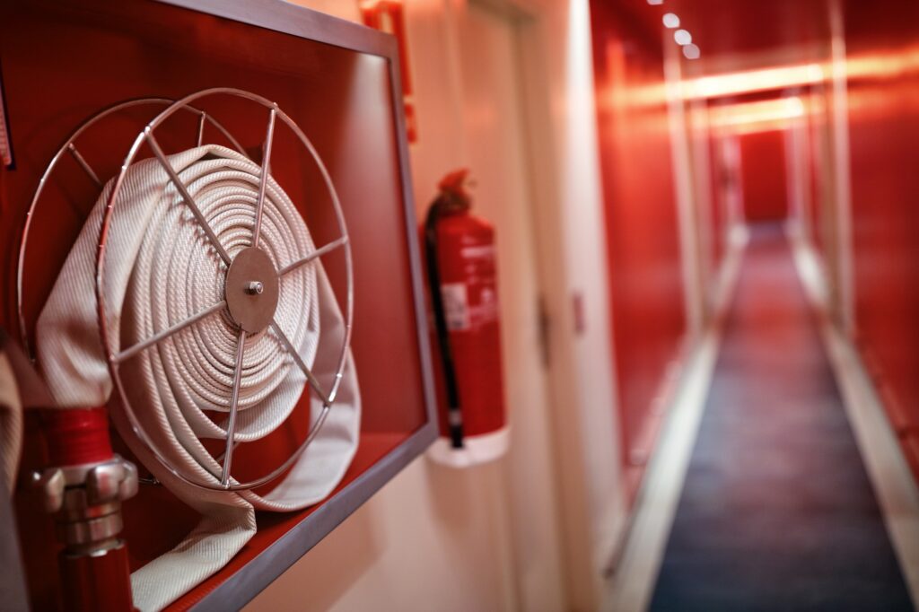 Fire extinguisher and hose reel in hotel corridor